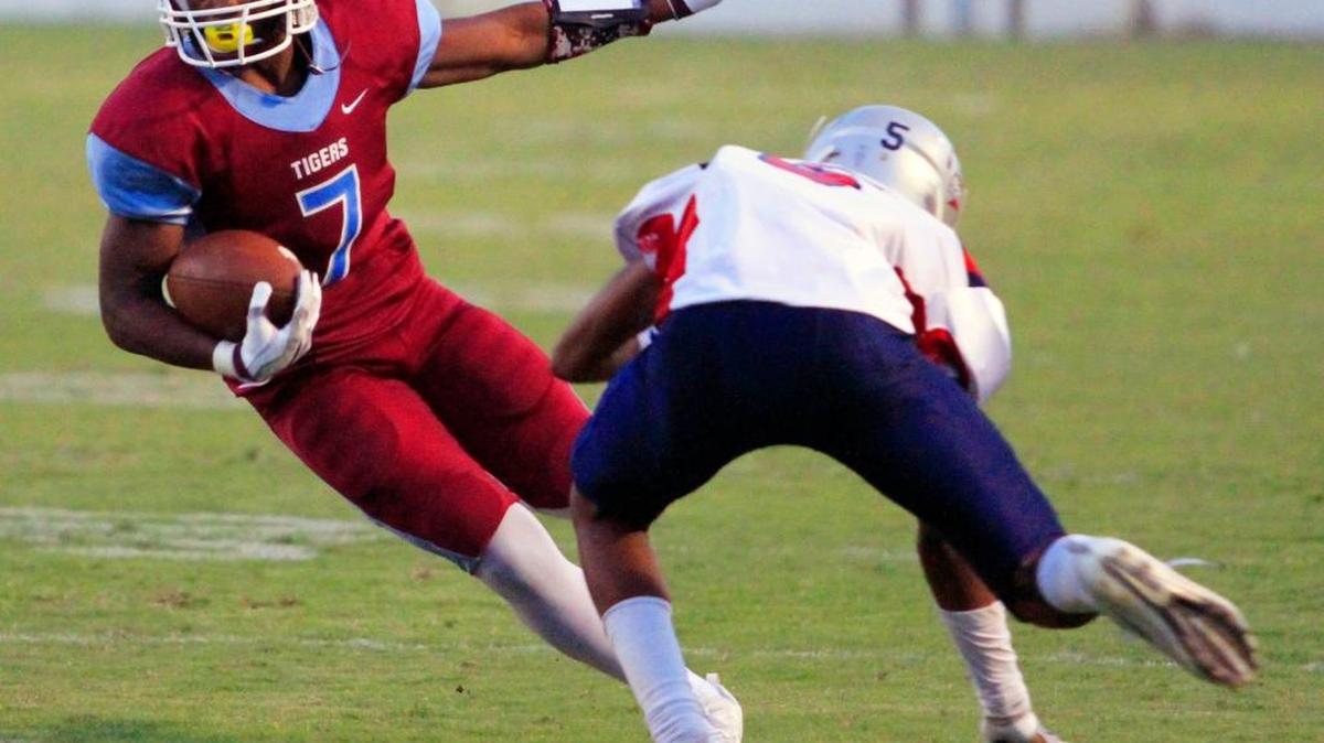 Carver running back Cameron Jessie cuts past Northside defender Trey Giles in the first half Friday night at A.J. McClung Memorial Stadium in Columbus.