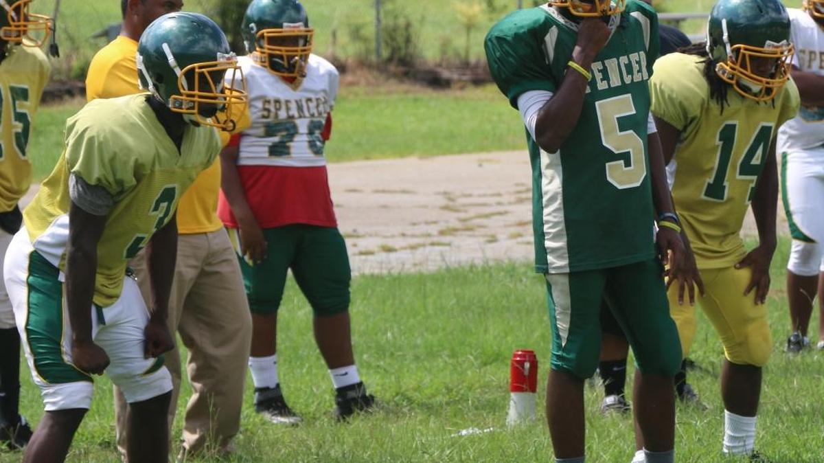 Quarterback Khalil Thomas (5) is flanked by Jaquaveious Moore (3) and Jaharee Mons (14) during practice. Spencer went 8-4 last season, its first winning record since 1977, and is trying to build on that this season.