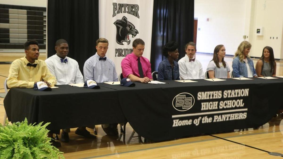 Nine Smiths Station athletes signed scholarships on Wednesday at the school. From left: Stephon Jackson (Highland C.C. basketball), William Peabody (Highland C.C. basketball), Austin Taylor (South Alabama football), Moss Saccomanna (Alabama Prep football), Ises Taylor (Talladega College track), Jacob Crouch (Auburn-Montgomery track), Lauren Camp (Alabama State soccer), Hanna Reid (Auburn-Montgomery soccer), and Taylor Lane (Wallace-Dothan softball).