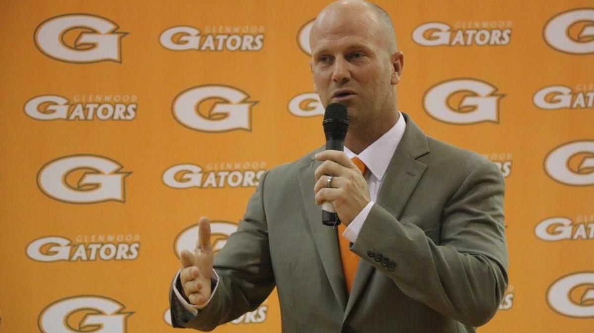 Glenwood football coach Jason Gibson talks with the media after being introduced as the school’s new head coach.