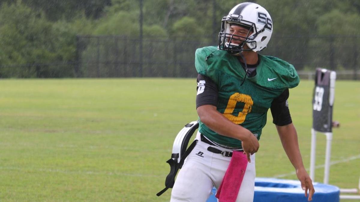 Smiths Station quarterback Jay Roberts warms up in the rain on Tuesday at practice.