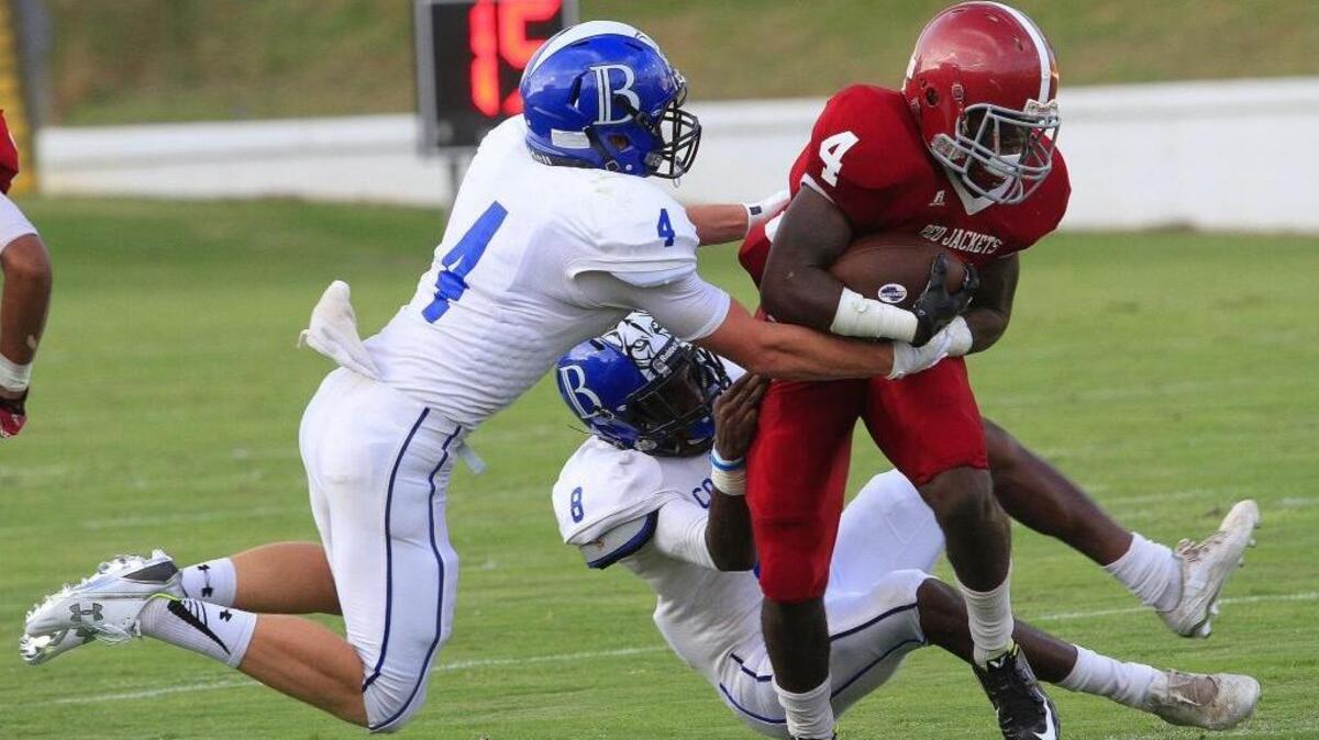 Jordan’s Jaden Jordan is brought down by Brookstone defenders Drake Beck (4) and Jeremiah Burgess (8) during a game last month.