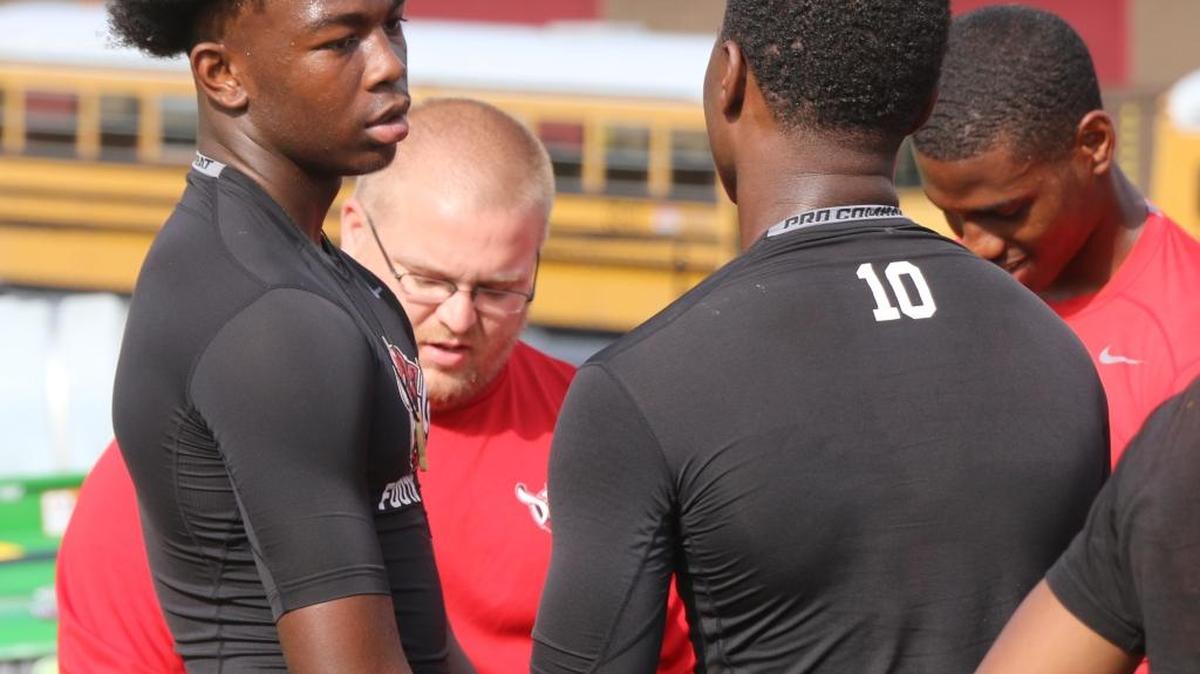 Central wide receiver Justyn Ross talks with quarterback Zion Webb on Thursday at a morning workout at the school. Both players are returning from ACL injuries. Webb has been cleared for full practice, while Ross is still recovering.