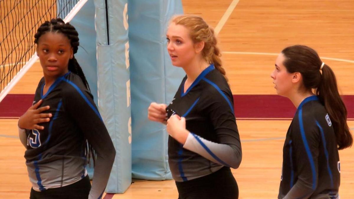 Columbus’ Tierra White, Savannah Ogle and Ashley Cox waits for their volleyball match against Northside to resume.