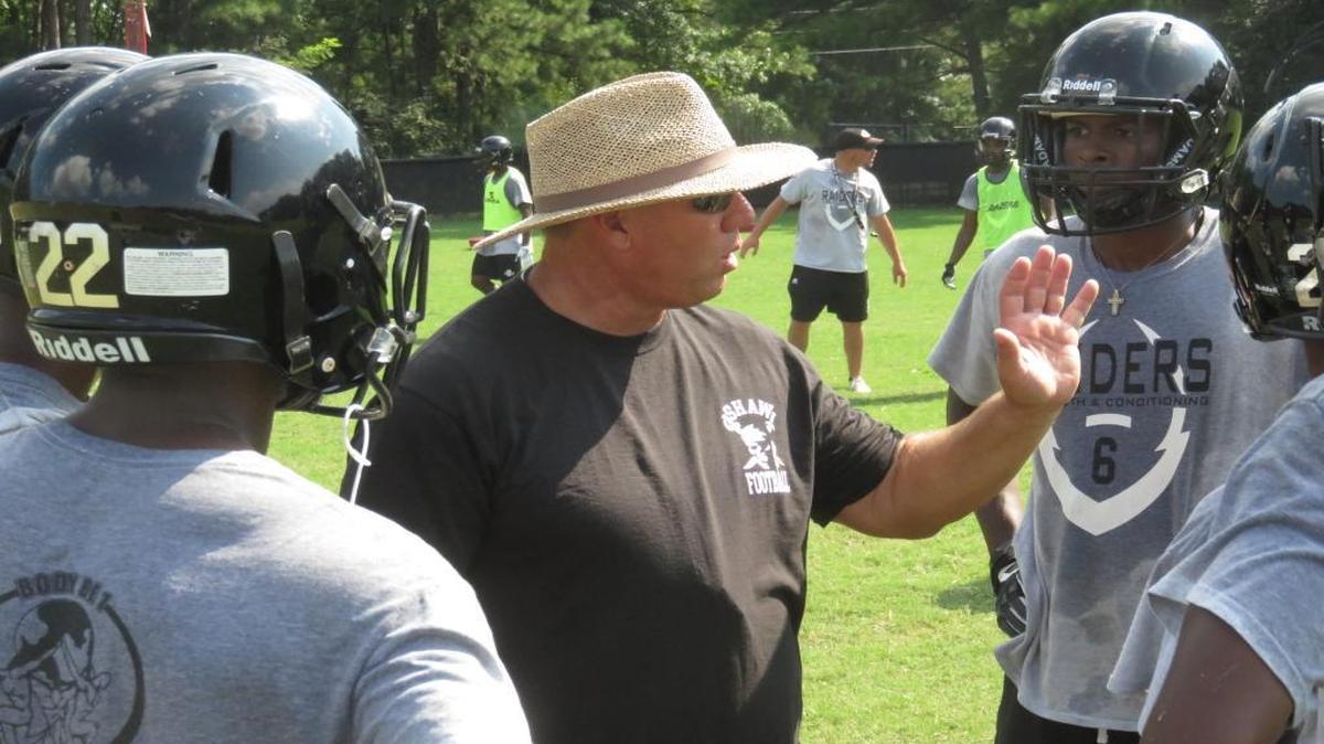 Shaw head coach Al Pellegrino talks to his Raiders offense during a summer practice.