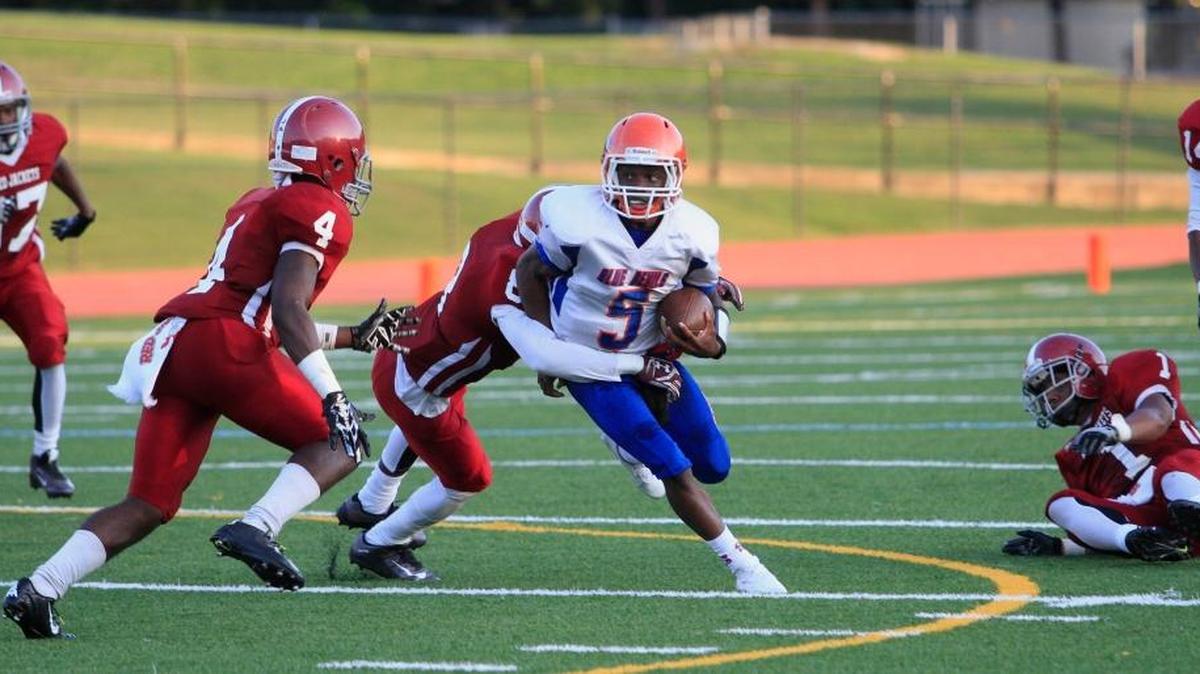 Columbus High QB Caleb Bailey tries to get past several Jordan defenders, including Jaden Jordan (4) and George McElroy (8) in a game last month.