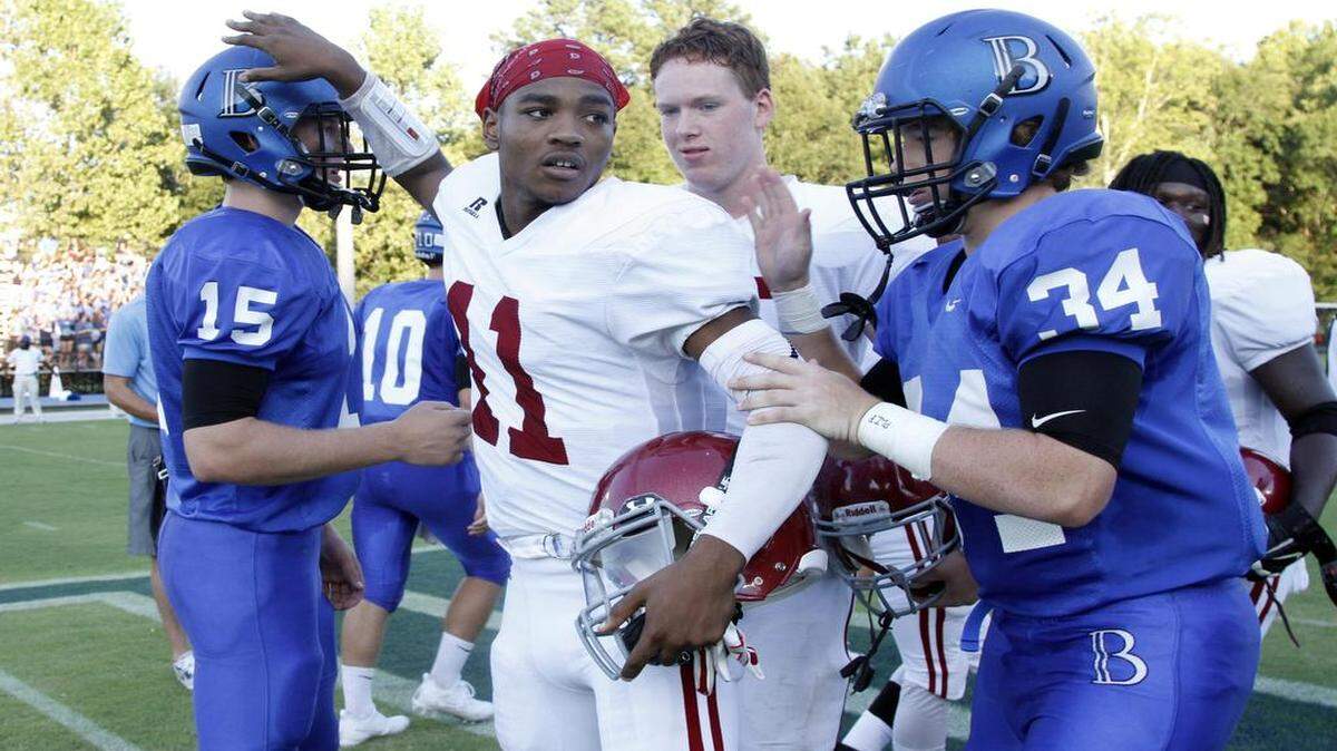 Team captains greet each other prior to the Jordan vs. Brookstone football game on Friday.
