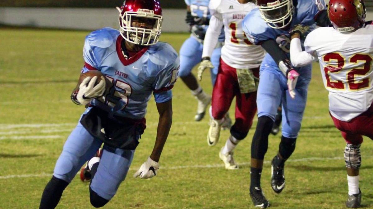 Carver running back Us Beasley breaks free for a long run and Carver’s first touchdown against Cross Creek on Nov. 11.