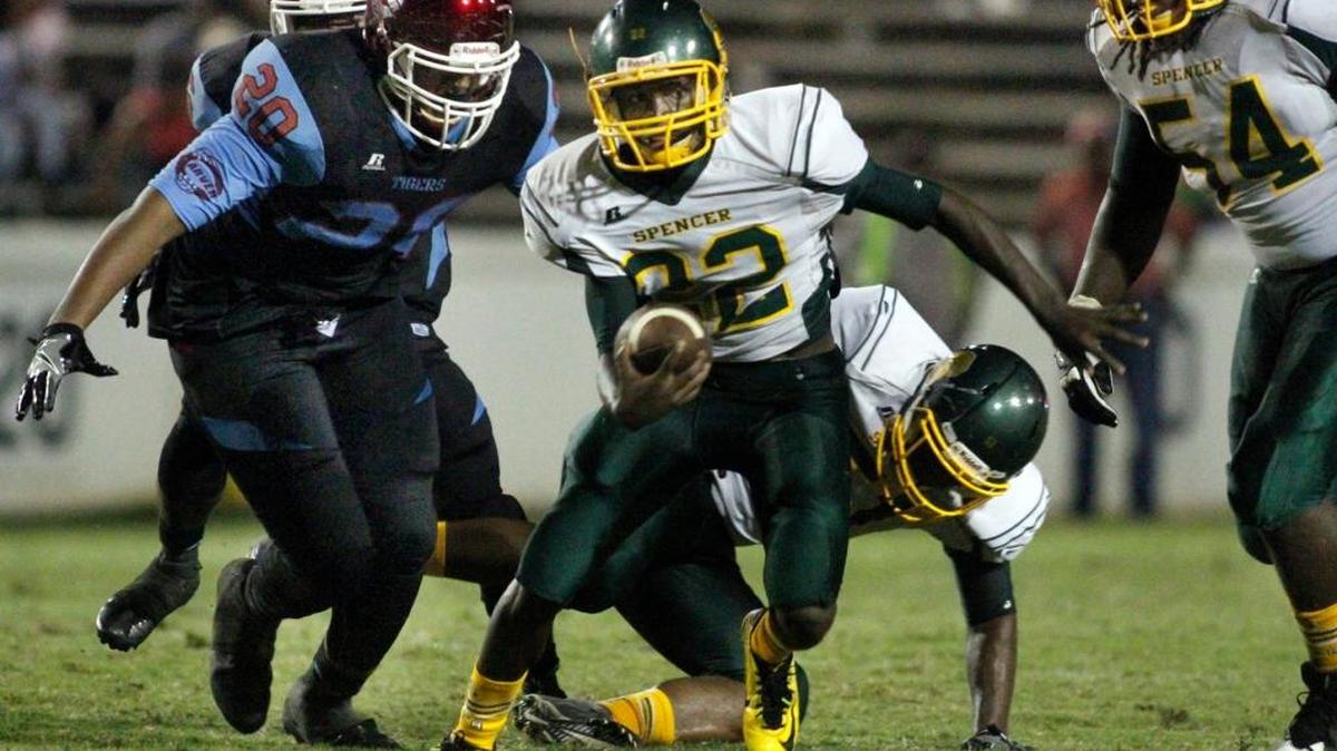 Spencer High running back Cory Calhoun rushes against Carver High in the Heritage Bowl earlier this season.