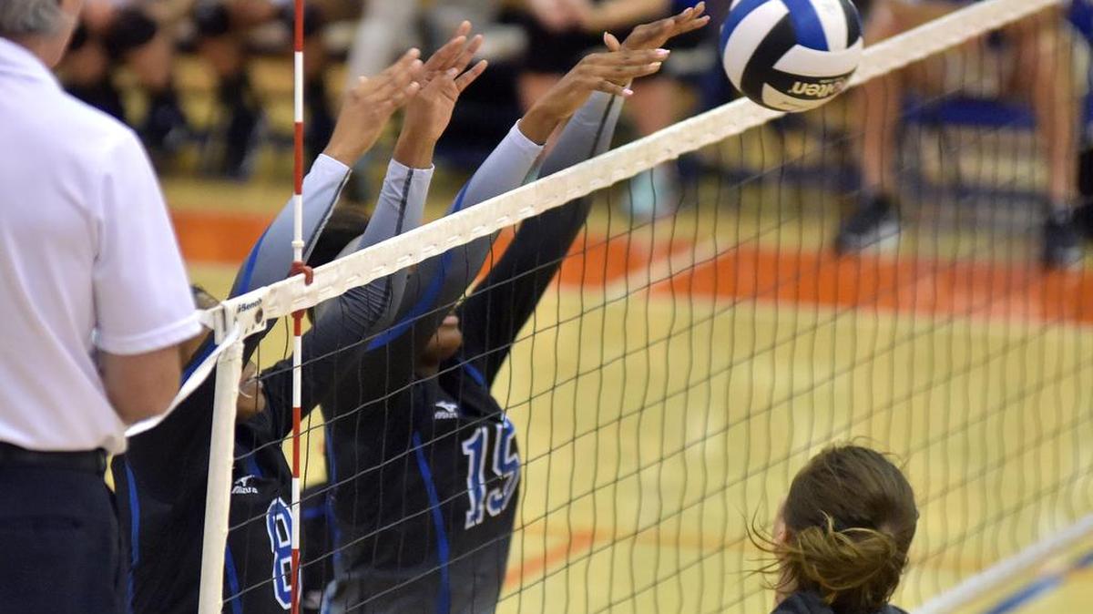 Columbus’ Nyah Whittlesey and Tierra White block the shot by Northside’s Katie Jordan in the first set of the Area 1-4A championship match Thursday night at Columbus High School.