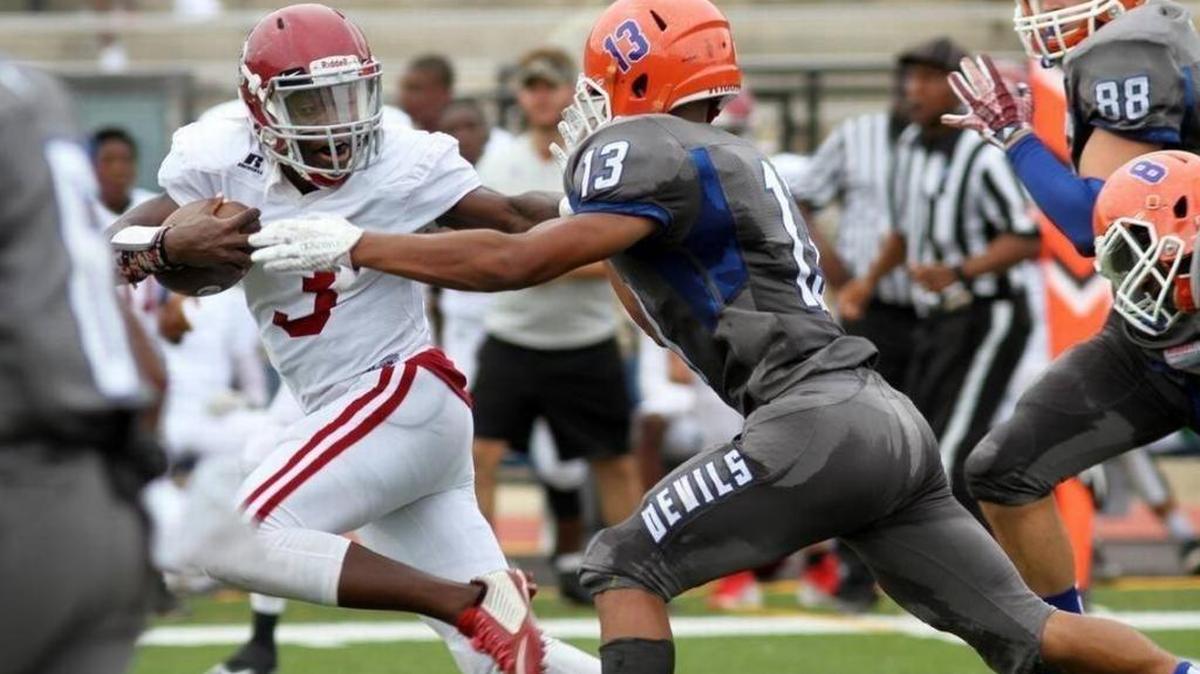 Jordan High's Emmanuel Mann stiff arms Columbus High's Anthony Bonner on his way to a 61-yard touchdown run during the Muscogee County School District Fall Classic at Kinnett Stadium