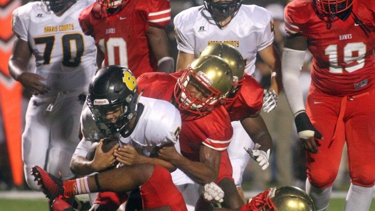 Hardaway defenders hit Harris County quarterback Davion Mahone on Saturday, August 26 at Kinnett Stadium.