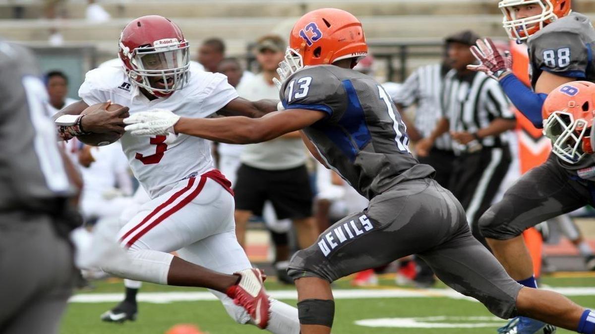 Jordan High's Emmanuel Mann stiff arms Columbus High's Anthony Bonner on his way to a 61-yard touchdown run during the Muscogee County School District Fall Classic at Kinnett Stadium Saturday. The Blue Devils beat the Red Jackets 47-32.