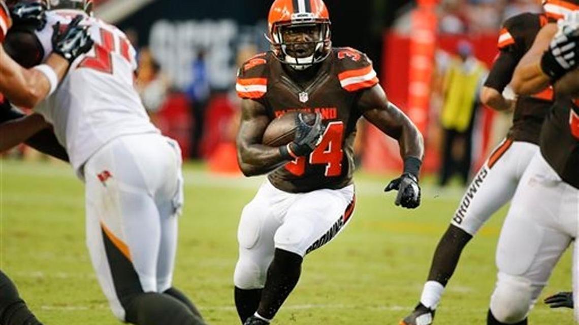 Cleveland Browns running back Isaiah Crowell (34) breaks through a hole during against the Tampa Bay Buccaneer during the first half of their NFL preseason game on Saturday, Aug. 29, 2015, in Tampa, Fla.
