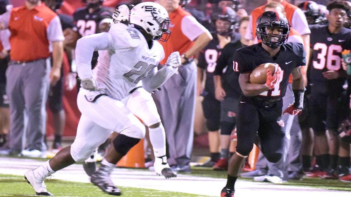 Smiths Station's D.J. Moffett drives Central's Jamaar Spivey out of bounds near the 20-yard line. Central won the game 62-7.