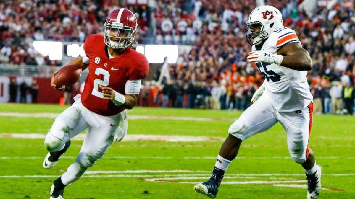 Alabama quarterback Jalen Hurts (2) scrambles past Auburn defensive lineman Carl Lawson (55) and runs in for a touchdown during the first half of the Iron Bowl NCAA college football game, Saturday, Nov. 26, 2016, in Tuscaloosa, Ala. (AP Photo/Butch Dill)