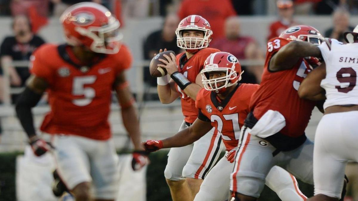 Georgia quarterback Jake Fromm (11) looks downfield as receiver Terry Godwin (5) goes long for the bomb and the first score of the Bulldogs' game against Mississippi State.