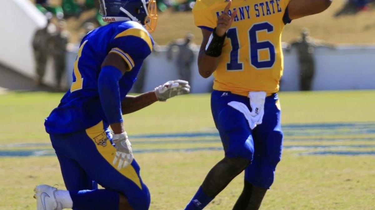 Albany State QB Caleb Edmonds gets off a pass while being chased by Fort Valley defender Brian Walker in the first half Saturday afternoon.
