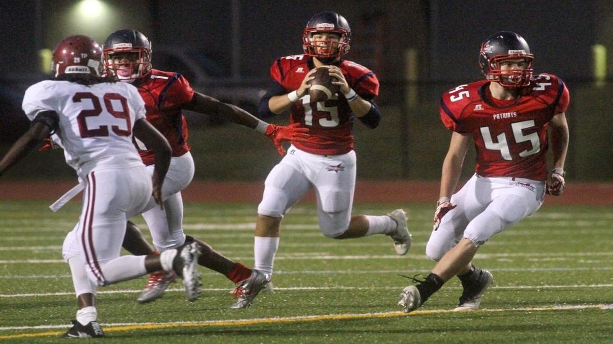 Northside High quarterback looks for a receiver behind the blocking of Fred Davis, left, and Owen Schilke against Jordan High at Kinnett Stadium Friday