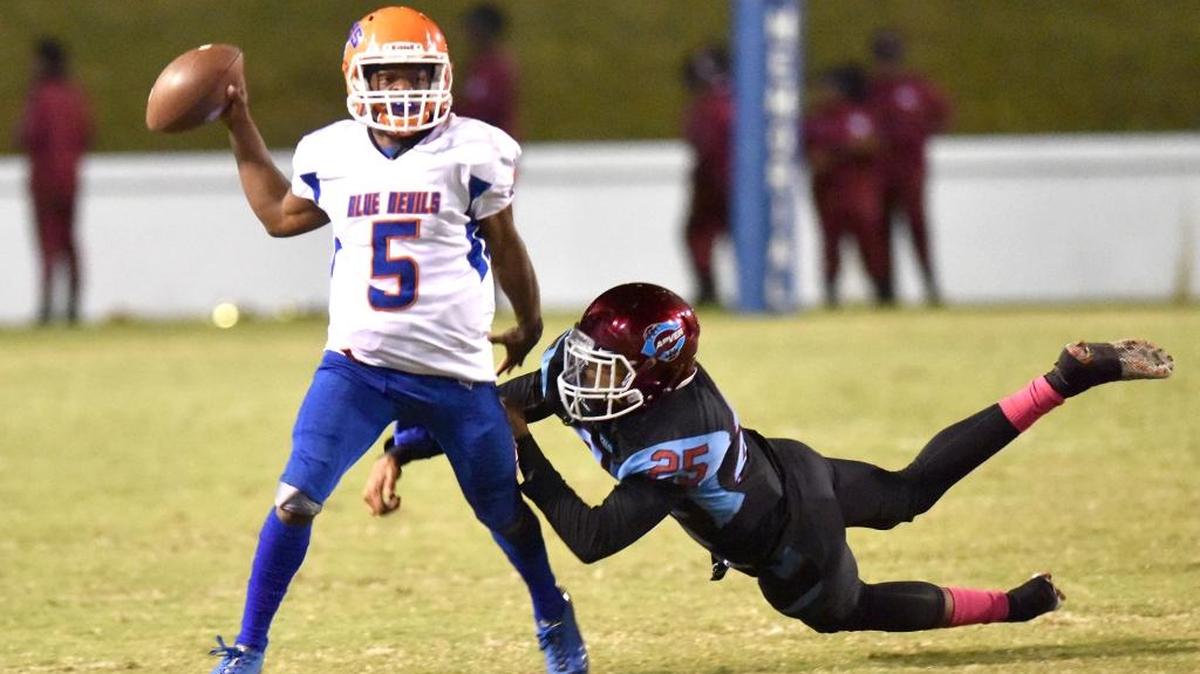 Columbus' Caleb Bailey scrambles away from Carver's Thomas Cook for a completed pass in the second quarter of the game Firday night, October 20, 2017