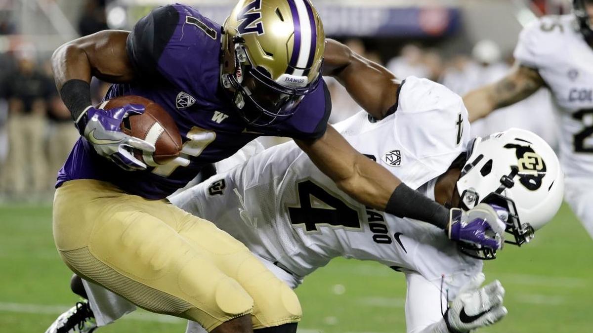Washington wide receiver John Ross (1) stiff-arms Colorado defensive back Chidobe Awuzie (4) during the first half of the Pac-12 Conference championship NCAA college football game Friday, Dec. 2, 2016, in Santa Clara, Calif.