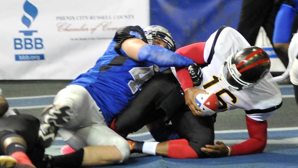Columbus Lions' Logan Ingle sacks Georgia Firebirds' Marcus Brooks for a safety and the Lion’s first points of the season Sunday afternoon at the Columbus Civic Center.