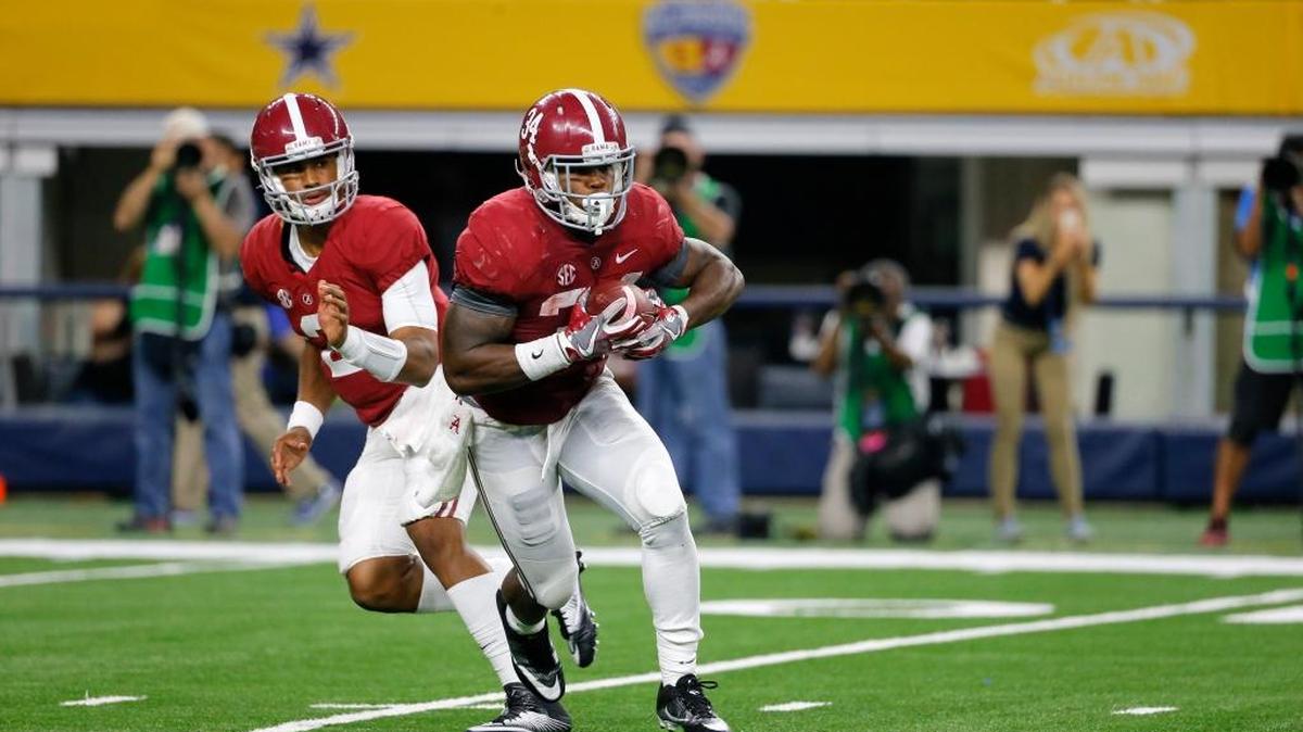 Alabama running back Damien Harris (34) takes the hand off from quarterback Jalen Hurts, rear, during an NCAA college football game against Southern California on Saturday, Sept. 3, 2016, in Arlington, Texas.