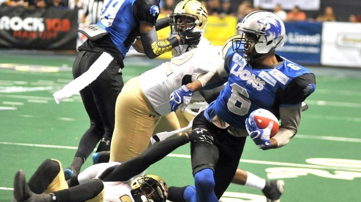 The Columbus Lions’ Jarmon Fortson spins out of the grasp of Michigan’s Corey Edwards during a 2016 game.