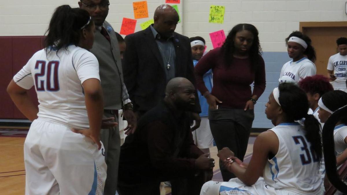 Carver head coach Anson Hundley talks strategy with his team during the Lady Tigers’ semifinal game against Shaw at Carver on February 9, 2017.