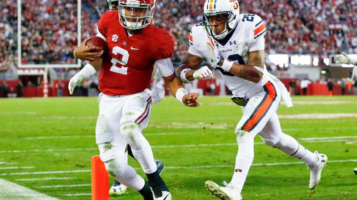 Auburn defensive back Tray Matthews pushes Alabama quarterback Jalen Hurts as he runs in for a touchdown during their Nov. 26 game in Tuscaloosa, Ala.