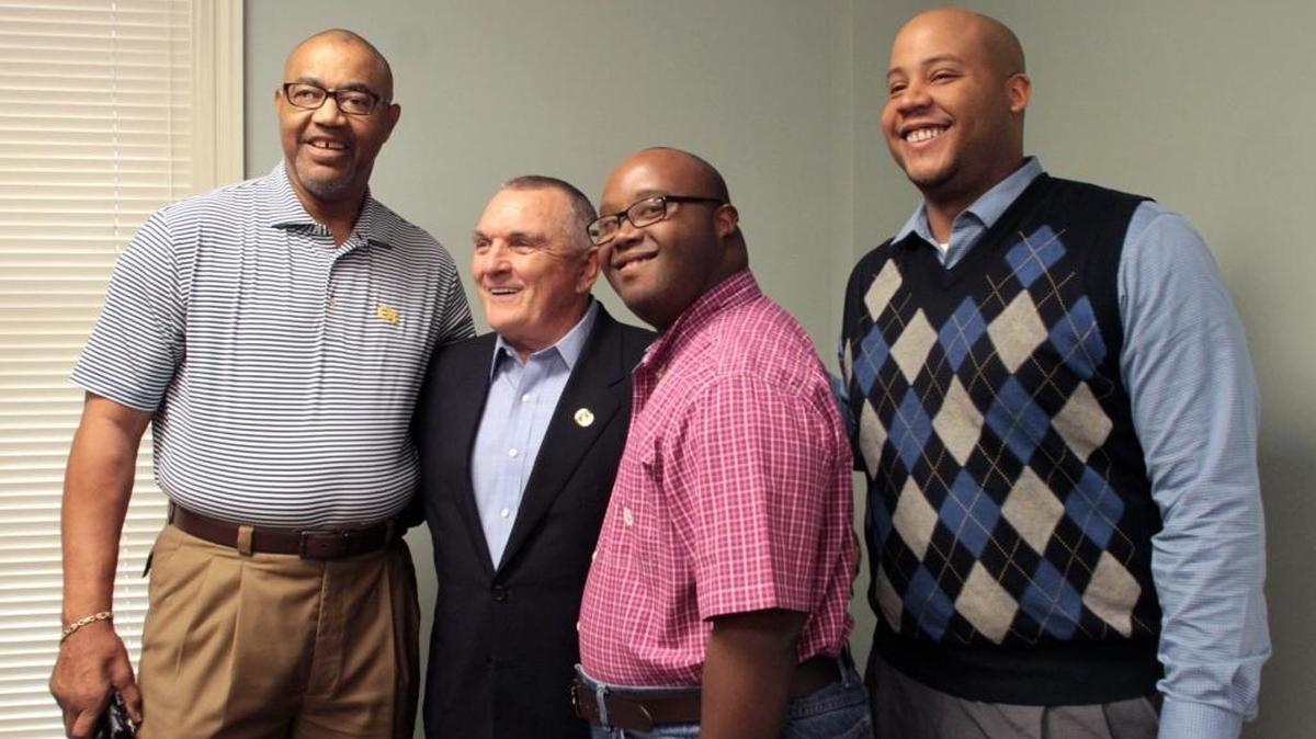 Former Notre Dame football player Rudy Ruettiger, second from left, stands with former Georgia Tech quarterback Rev. Rudy Allen, left, and Allen's sons Rev. Rudy Allen, III, center right, and Pastor Justin Allen.