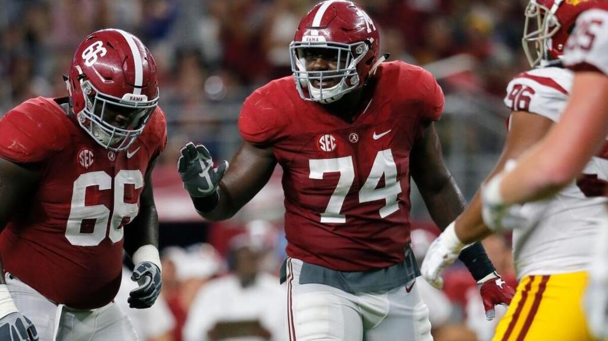 FILE - In this Sept. 3, 2016, file photo, Alabama offensive lineman Lester Cotton (66) and offensive lineman Cam Robinson (74) line up against Southern California during an NCAA college football game in Arlington, Texas. Robinson was one of three Crimson Tide players selected to the 2016 AP All-America college football team as unanimous picks.