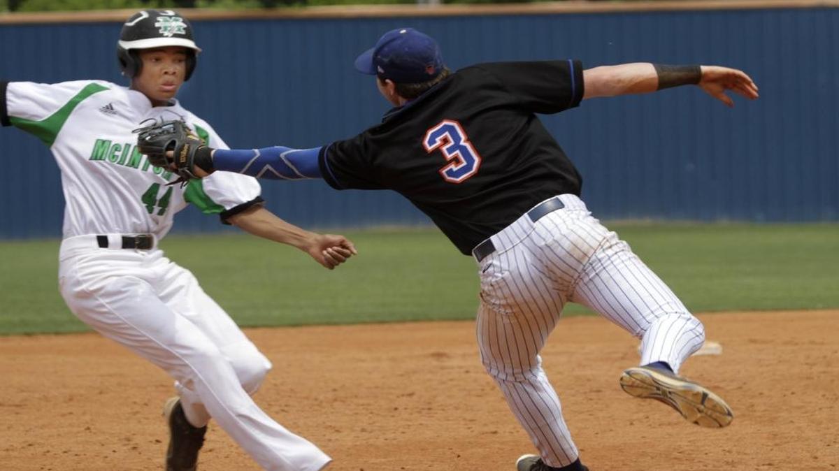 Columbus High third baseman Jack Copley stretches to tag Andrew Pinckney of McIntosh in game three of the first round of GHSA Class 5A playoffs at Columbus Saturday. Pinckney was called safe at third, a call argued by Columbus coach Chad Mathis.