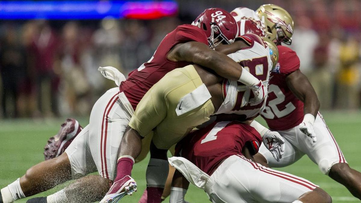 Alabama defensive lineman Da'Ron Payne (94) and defensive back Trevon Diggs (7) tackle Florida State wide receiver Keith Gavin (89) during the firs half of an NCAA college football game, Saturday, Sept. 2, 2017, in Atlanta.