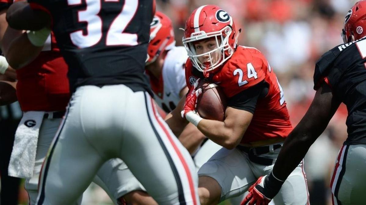 Red team tail back Prather Hudson (24) carries to set up the first touchdown of the G-Day Game in 2017.
