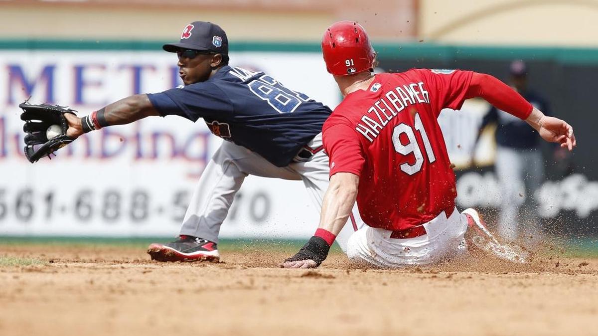 St. Louis baserunner Jeremy Hazelbaker safely steals second base, beating the tag by Atlanta shortstop Ozzie Albies during the fourth inning of a spring training baseball game in March.