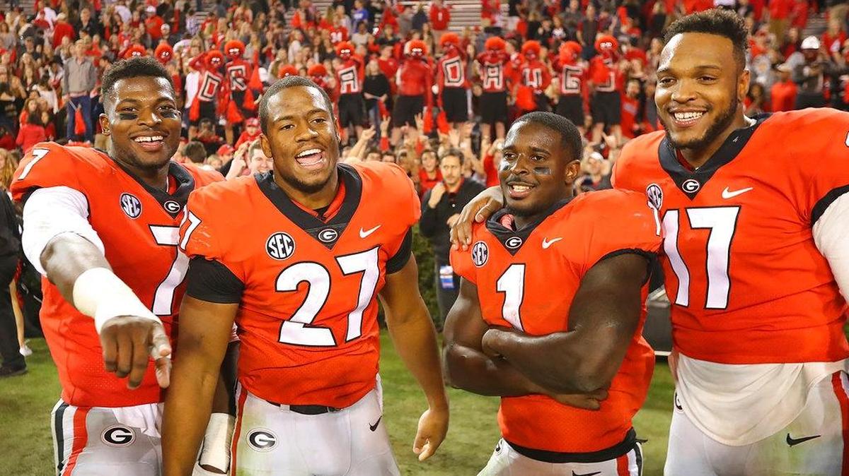 Georgia seniors, from left, Lorenzo Carter, Nick Chubb, Sony Michel, and Davin Bellamy celebrate their 42-13 victory over Kentucky in an NCAA college football game, Saturday, Nov. 18, 2017, in Athens, Ga.