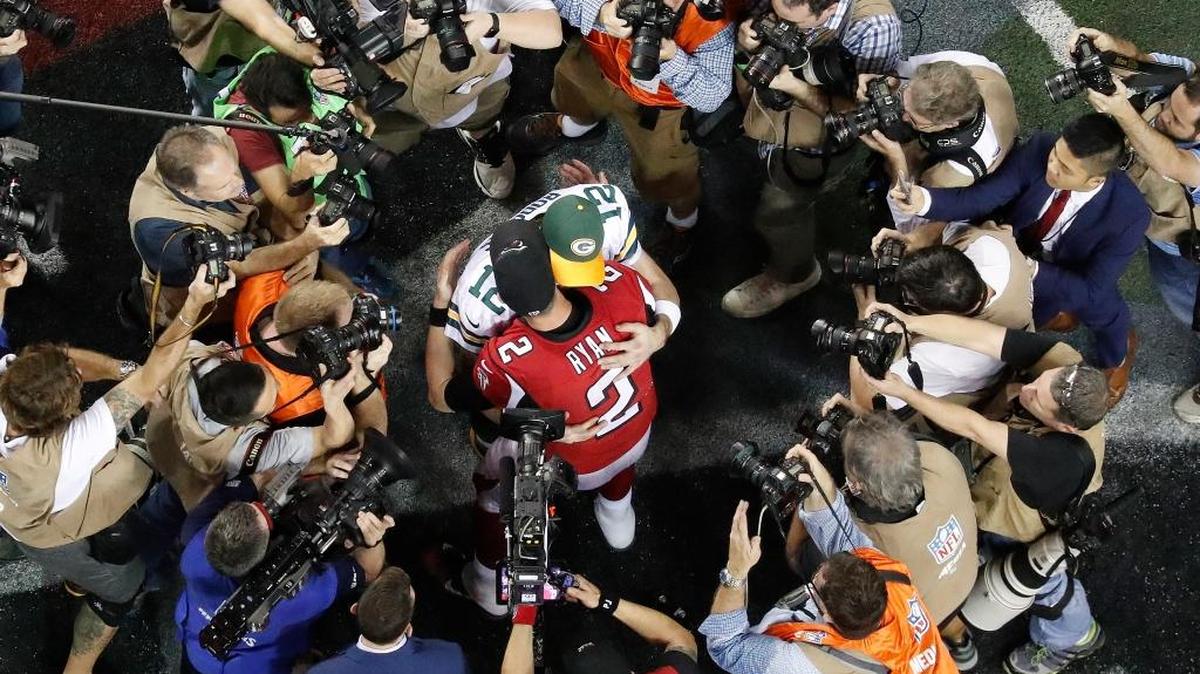 Atlanta’s Matt Ryan (2) embraces Green Bay’s Aaron Rodgers after the NFC Championship on Sunday in Atlanta.