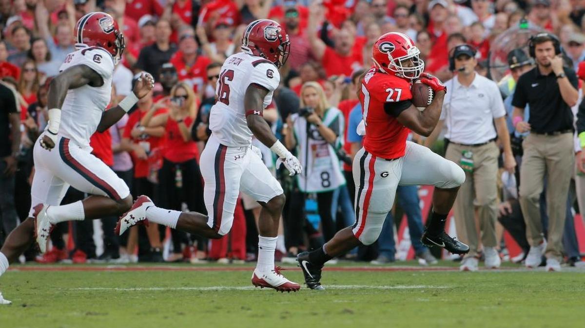 Georgia running back Nick Chubb (27) breaks a long first-quarter run against South Carolina at Sanford Stadium in Athens, Ga., on Saturday, Nov. 4, 2017.
