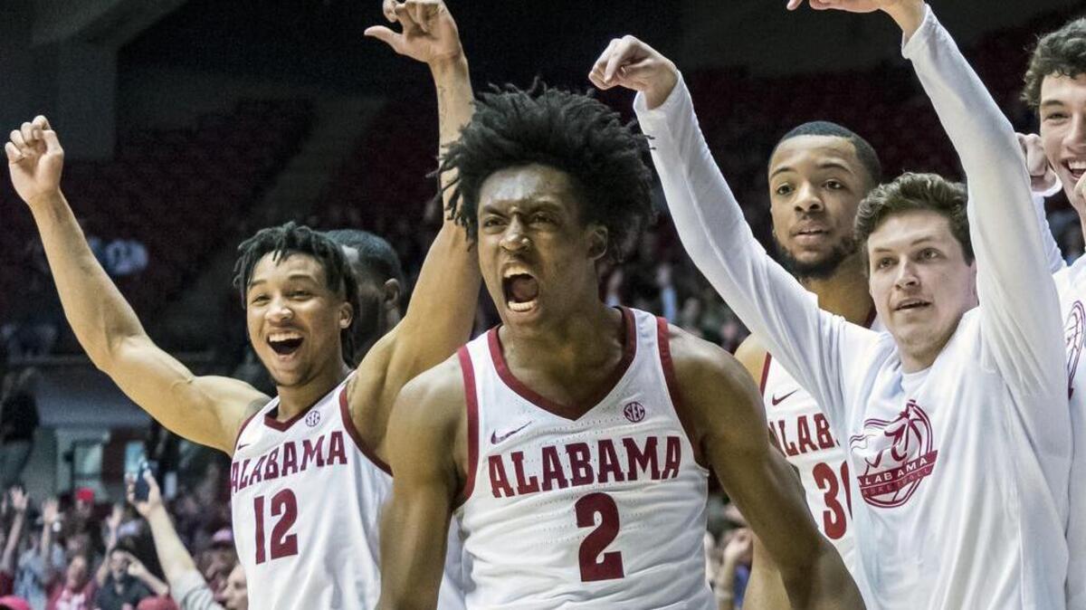 FILE - In this Feb. 13, 2018, file photo, Alabama guard Collin Sexton (2) and teammates cheer forward Donta Hall after he dunked against LSU during the second half of an NCAA college basketball game, in Tuscaloosa, Ala. Bank records and other expense reports that are part of a federal probe into college basketball list a wide range of impermissible payments from agents to at least two dozen players or their relatives, according to documents obtained by Yahoo Sports. Yahoo said Friday, Feb. 23, 2018, that the documents obtained in discovery during the investigation link current players including Michigan State's Miles Bridges, Duke's Wendell Carter and Alabama's Collin Sexton to potential benefits that would be violations of NCAA rules.