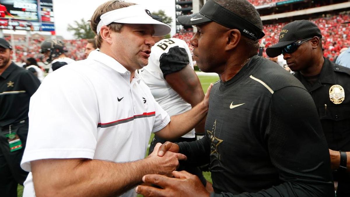 Georgia head coach Kirby Smart, left, and Vanderbilt head coach Derek Mason meet at midfield after in an NCAA college football game Saturday, Oct. 15, 2016, in Athens, Ga. Vanderbilt won 17-16.