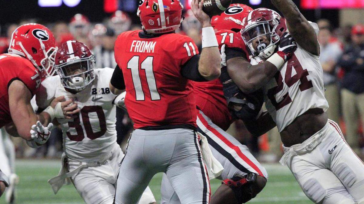 Georgia quarterback Jake Fromm though under pressure from the Alabama defense during the College Football Playoff National Championship game in Atlanta. The Crimson Tide went on to beat the Bulldogs 26-23 in overtime to win the title.