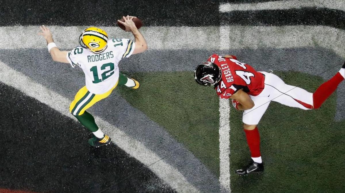 Green Bay Packers quarterback Aaron Rodgers (12) works as Atlanta Falcons outside linebacker Vic Beasley (44) defends during the second half of the NFL football NFC championship game Sunday, Jan. 22, 2017, in Atlanta.