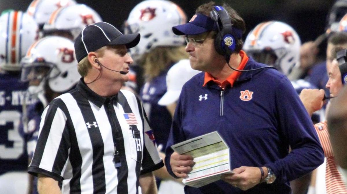 Auburn head coach Gus Malzahn talks with an official during the SEC Championship at Mercedes Benz Stadium in Atlanta Saturday. The Tigers lost to Georgia 28-7.