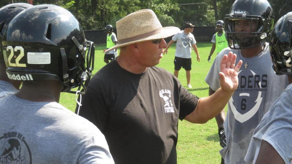 Shaw head coach Al Pellegrino talks to his Raiders offense during a summer practice.