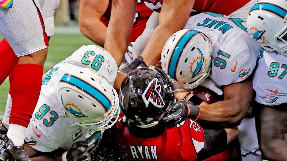 Miami Dolphins Ndamukong Suh (93) and Cameron Wake (91) sack Atlanta Falcons quarterback Matt Ryan (2) in the second quarter Sunday, Oct. 15, 2017, at the Mercedes-Benz Stadium in Atlanta.