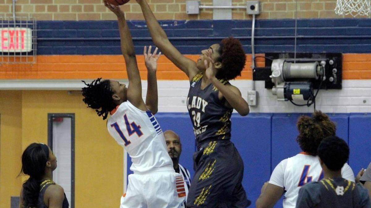 Harris County's Jessika Carter, right, blocks a shot by Columbus High's Tatyana Wyatt during a January game. Carter had 12 points, 16 rebounds, and six blocks Tuesday against Newnan.