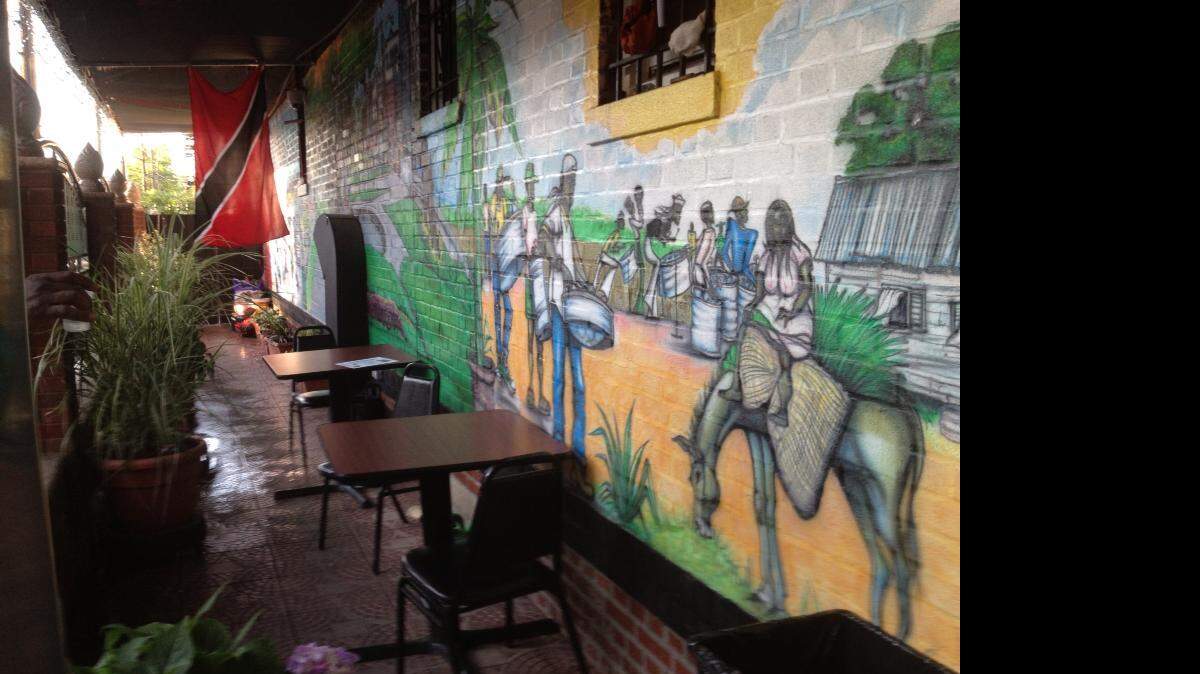 This colorful mural is displayed on the wall of a Caribbean restaurant in Brooklyn, N.Y., where neighborhoods are changing because of gentrification.