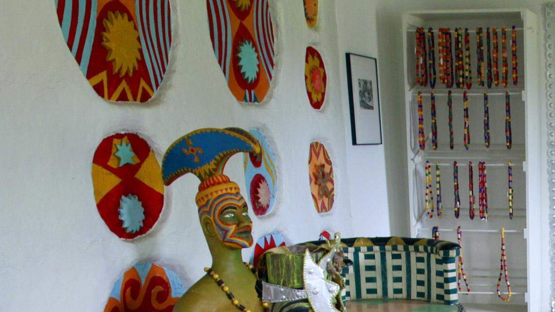 Skyler Mote sweeps the floor of the main house at Pasaquan Saturday morning during a clean-up day to prepare the site for upcoming visits from two different video crews. 07/27/13